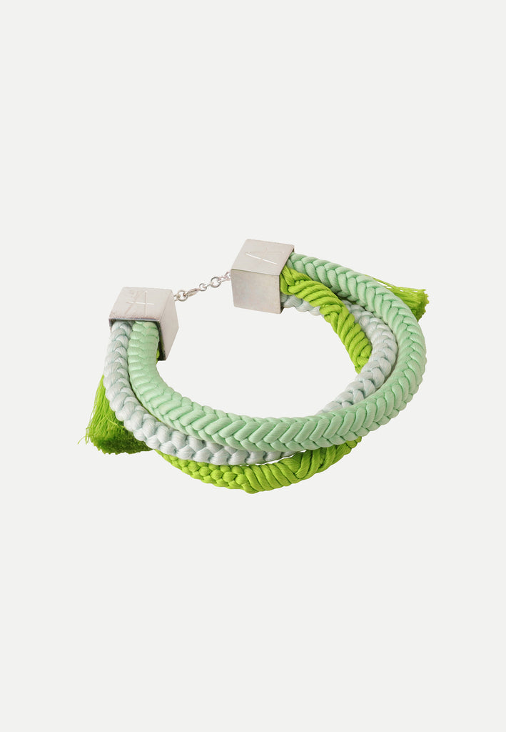 bracelet in different shades of green made from vintage silk obijime cords and sterling silver