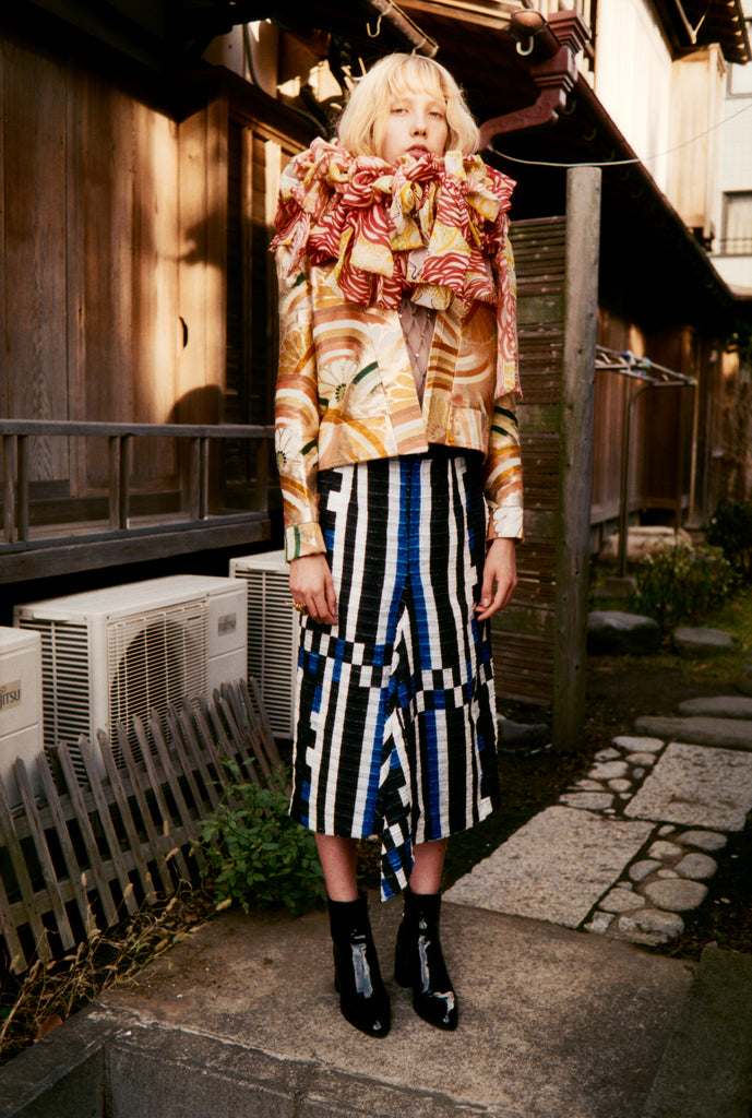 woman wearing gold kimono cropped jacket